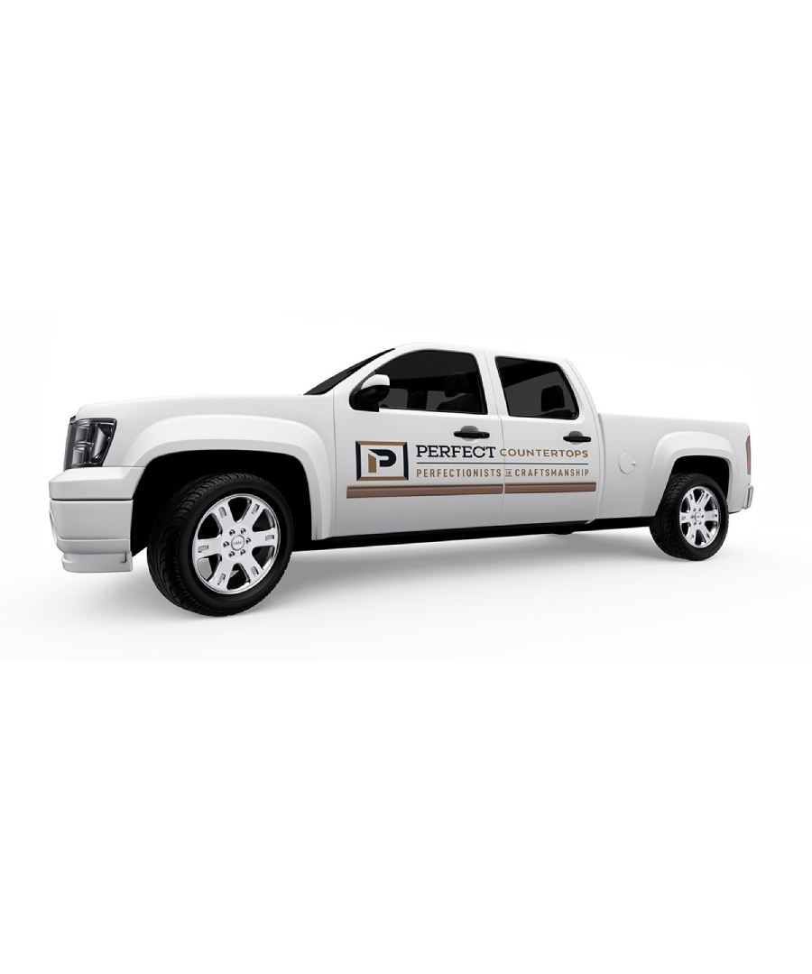 White pickup truck featuring the Perfect Countertops company branding on the side door. The logo includes a bold "P" icon, the company name in serif and sans-serif fonts, and the tagline “Perfectionists in Craftsmanship” framed with decorative lines, emphasizing professionalism and high-quality service.